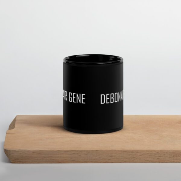 A black cup sitting on top of a wooden table.