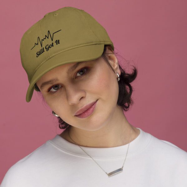 A woman wearing a hat with the words " you can 't take it ".