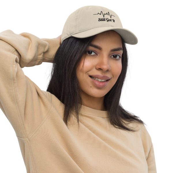 A woman in beige hat and sweater posing for the camera.